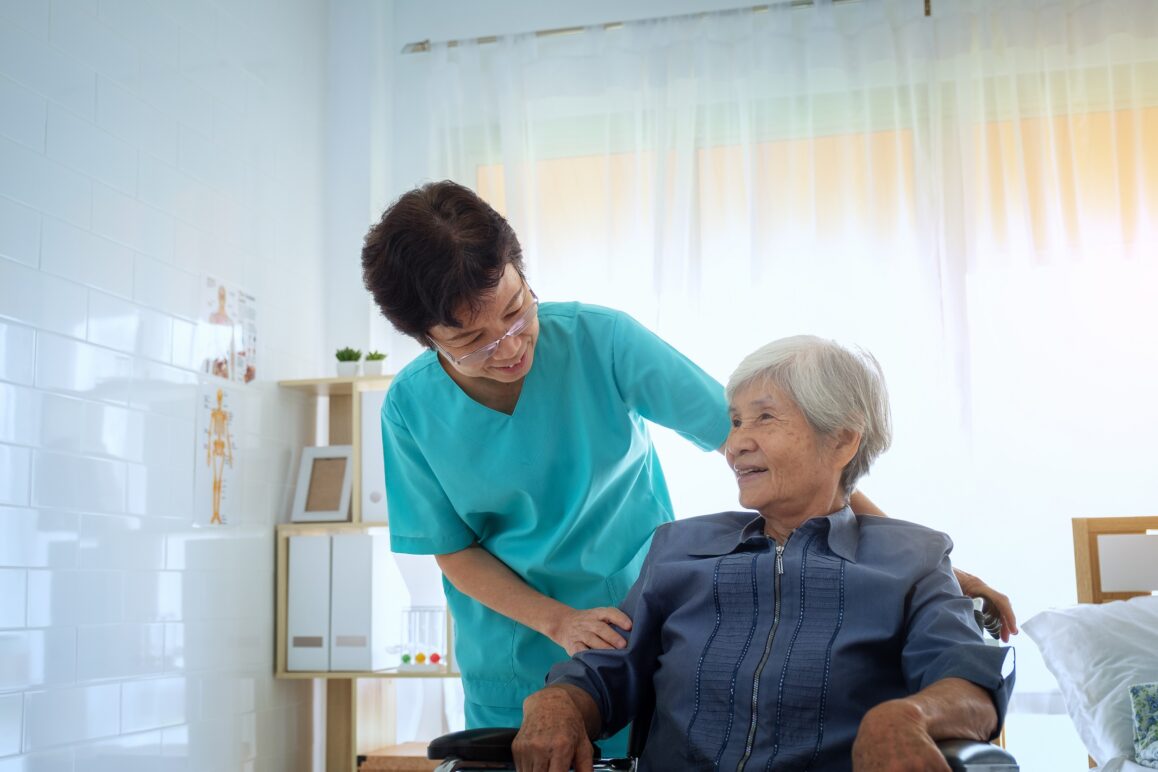 Delighted positive caregiver helping her patient, Nurse hugging